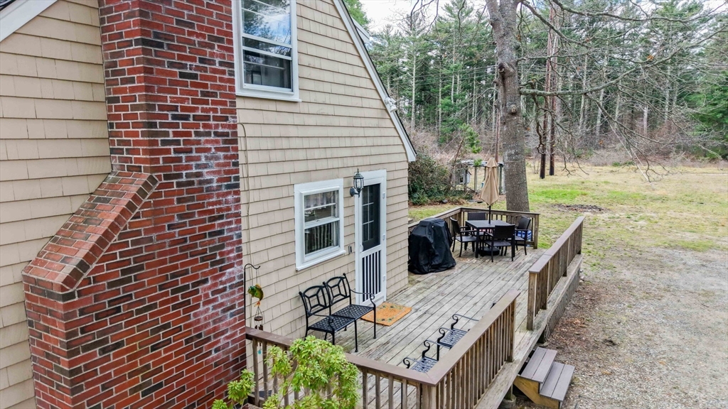 13 Albatross Avenue Wareham, MA 02538 - Photo 24 of 25 a view of a patio with table and chairs with wooden floor and fence