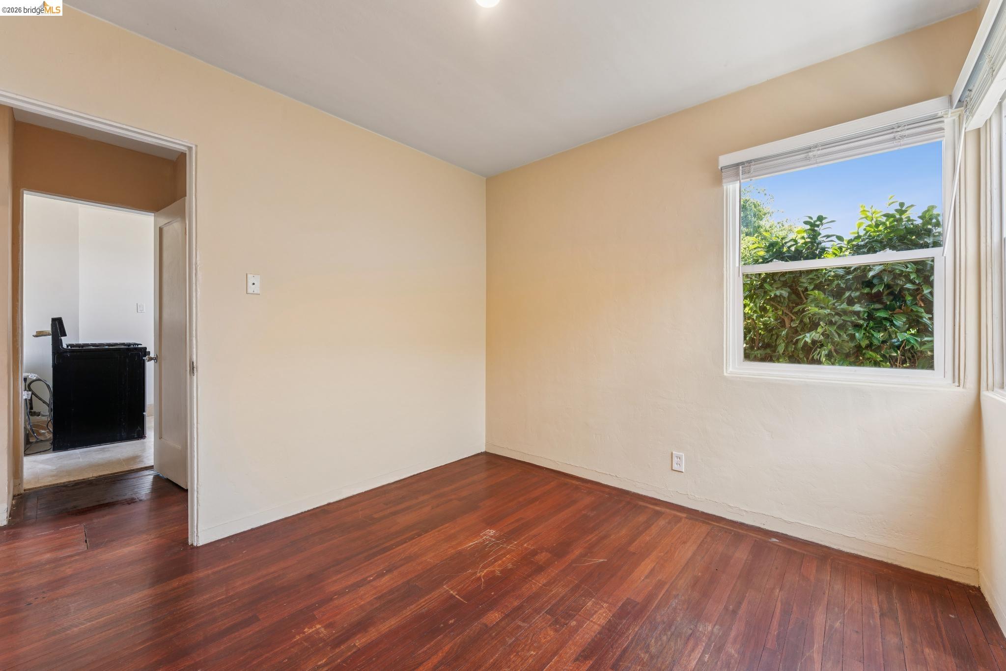 2879 Rheem Avenue Richmond, CA 94804 - Photo 33 of 45 Room featuring wood-finish flooring, neutral wall paint, a single window, and a recessed ceiling light