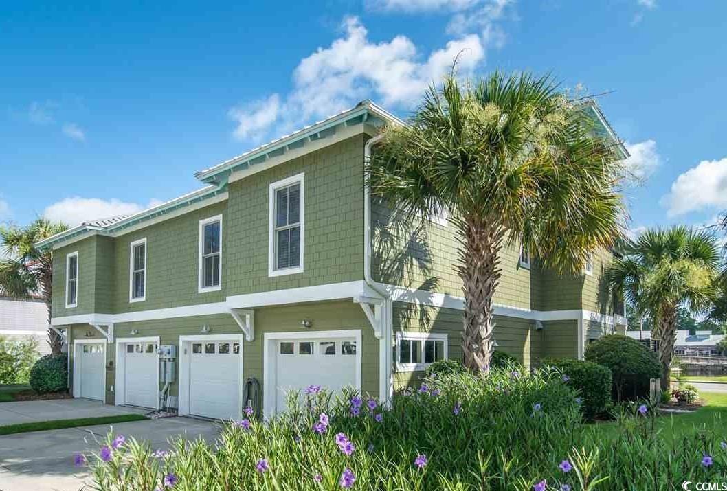 48 Lumbee Circle, Unit 8 Pawleys Island, SC 29585 - Photo 4 of 33 View of side of property with an attached garage and concrete driveway