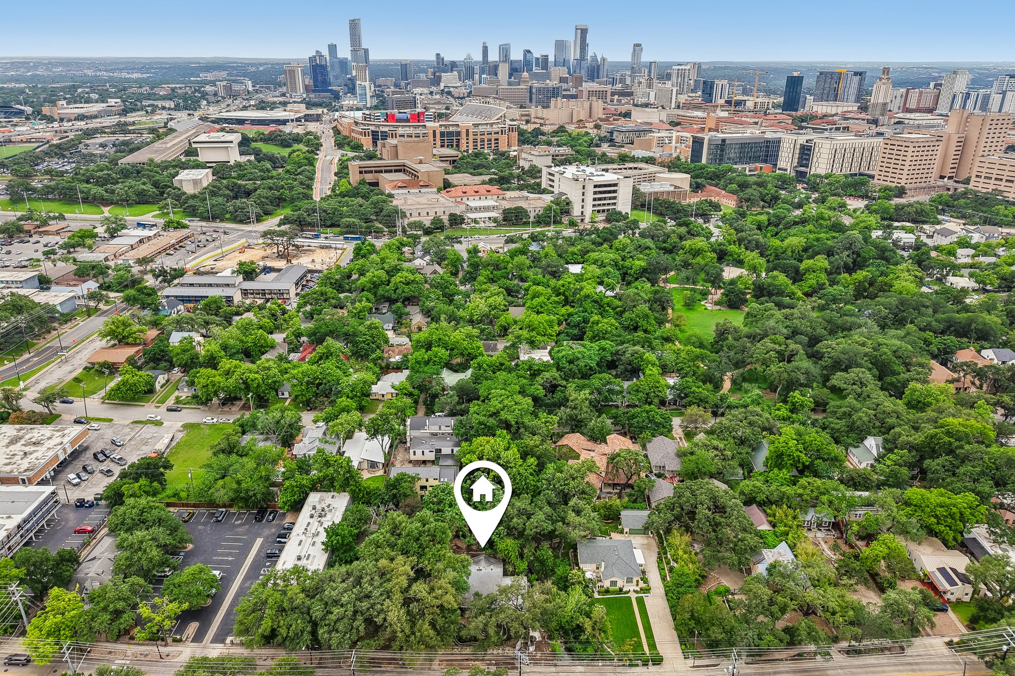 801 East 32nd Street Austin, TX 78705 - Photo 3 of 13 An aerial perspective reveals a tree-lined neighborhood offering a blend of residential comfort and urban convenience with city skyline views.