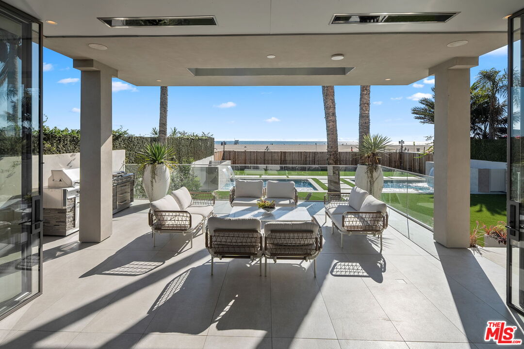 938-940 Palisades Beach Road Santa Monica, CA 90403 - Photo 12 of 72 a living room with patio furniture and garden view