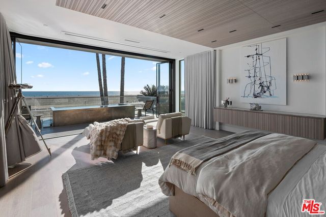 a bed room with a bed and a large window