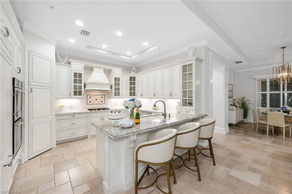 2306 Tradition Way, Unit 102 Naples, FL 34105 - Photo 5 of 39 Abundant cabinet storage with breakfast bar and walk-in pantry.