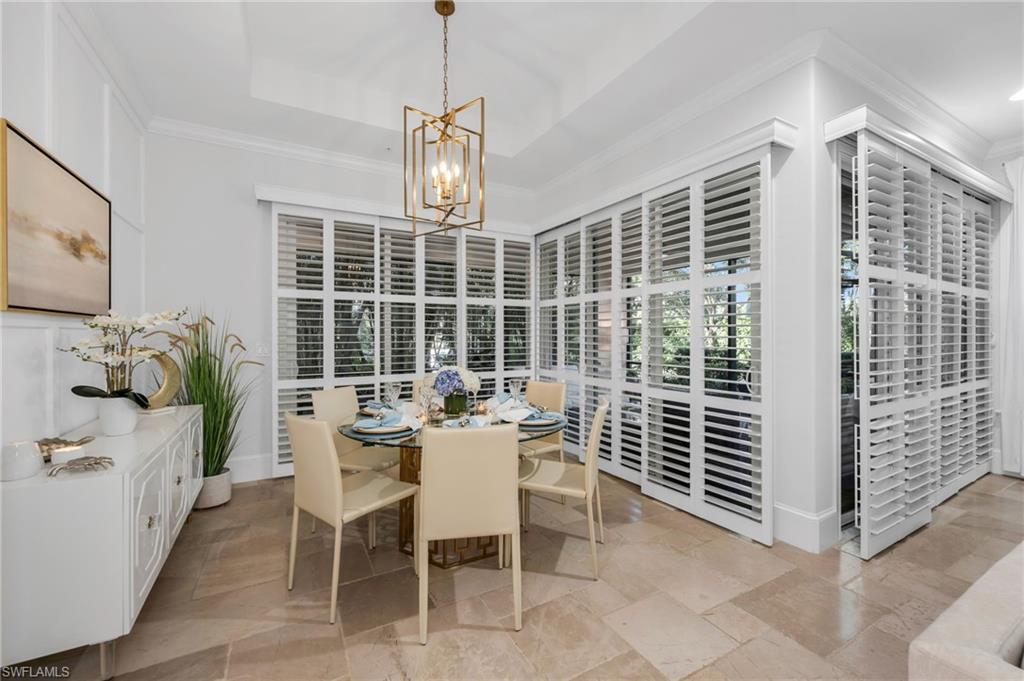 2306 Tradition Way, Unit 102 Naples, FL 34105 - Photo 6 of 39 Large dining room with plantation shutters and views to the lanai.