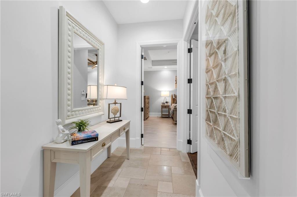 2306 Tradition Way, Unit 102 Naples, FL 34105 - Photo 7 of 39 Hallway leading to the Primary Suite.