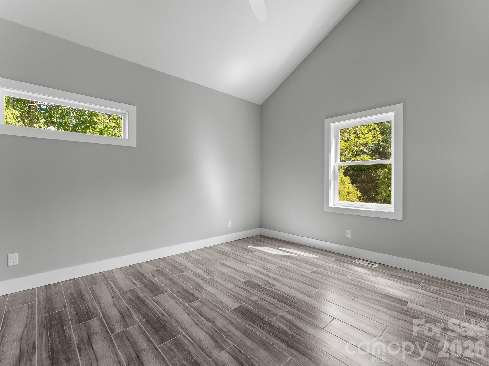 123 Israel Road Candler, NC 28715 - Photo 27 of 44 a view of an empty room with wooden floor and a window