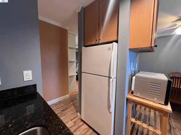 a kitchen with a refrigerator and a stove top oven