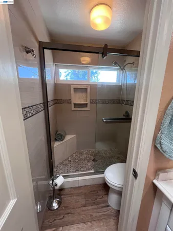 a bathroom with a toilet and a mirror