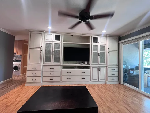 a view of a bedroom with furniture and cabinet