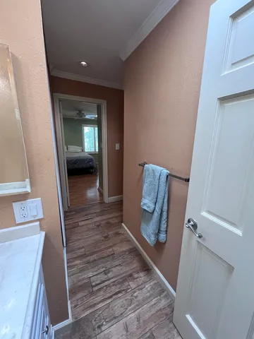 a view of a hallway with wooden floor and staircase