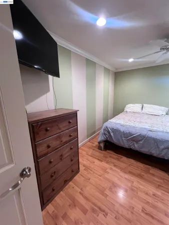 a bedroom with a bed and a television