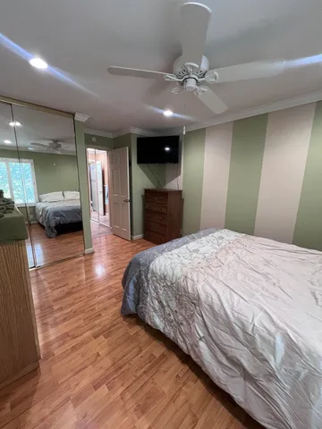 a spacious bedroom with a large bed and a chandelier