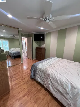 a spacious bedroom with a large bed and a chandelier