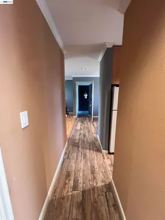 a view of a hallway with wooden floor