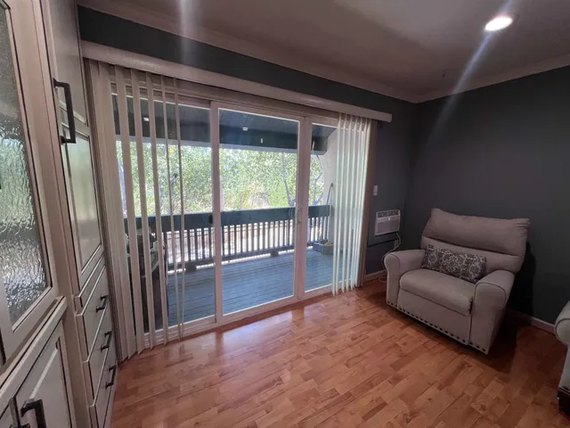 a living room with furniture and a floor to ceiling window