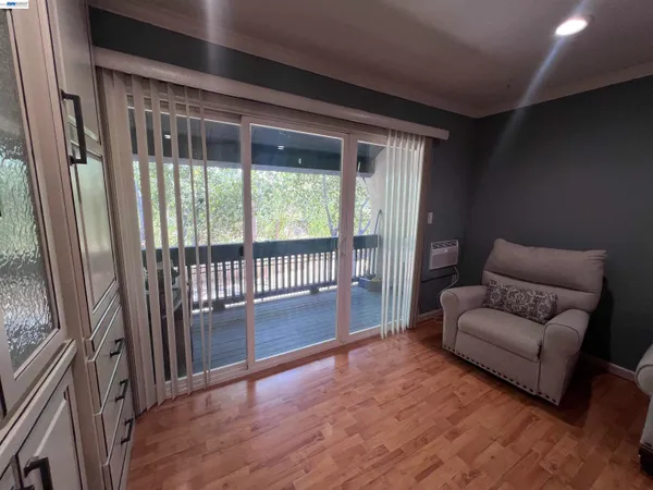 a living room with furniture and a floor to ceiling window