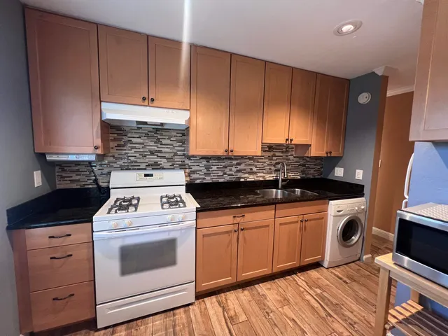 a kitchen with a stove and a sink