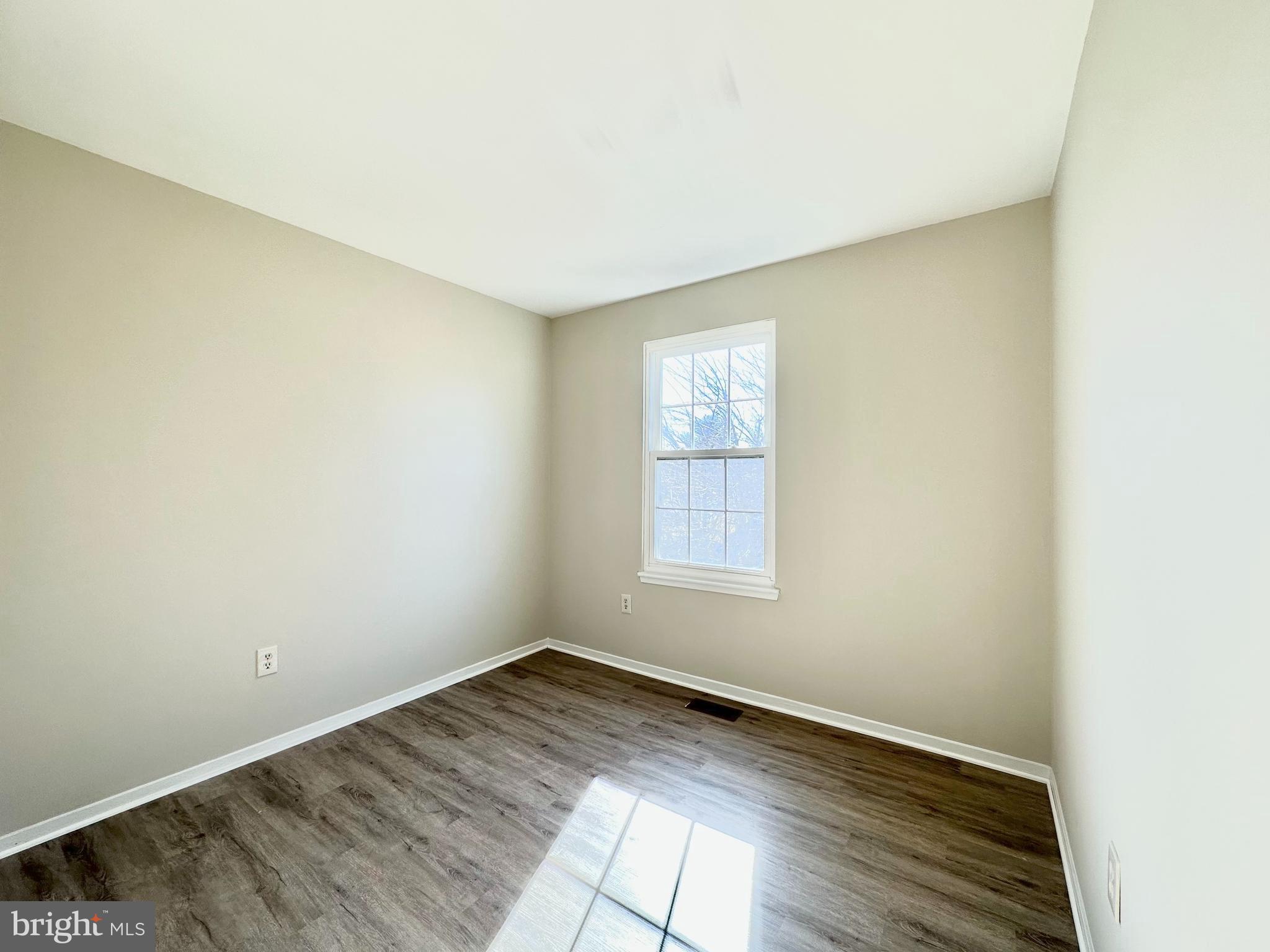 402 Carousel Court Gaithersburg, MD 20877 - Photo 21 of 29 an empty room with wooden floor and windows