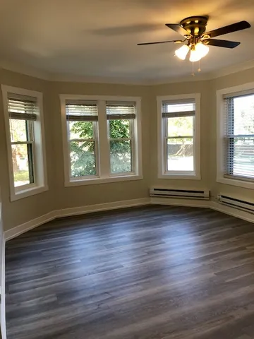 a view of a livingroom with a ceiling fan and window