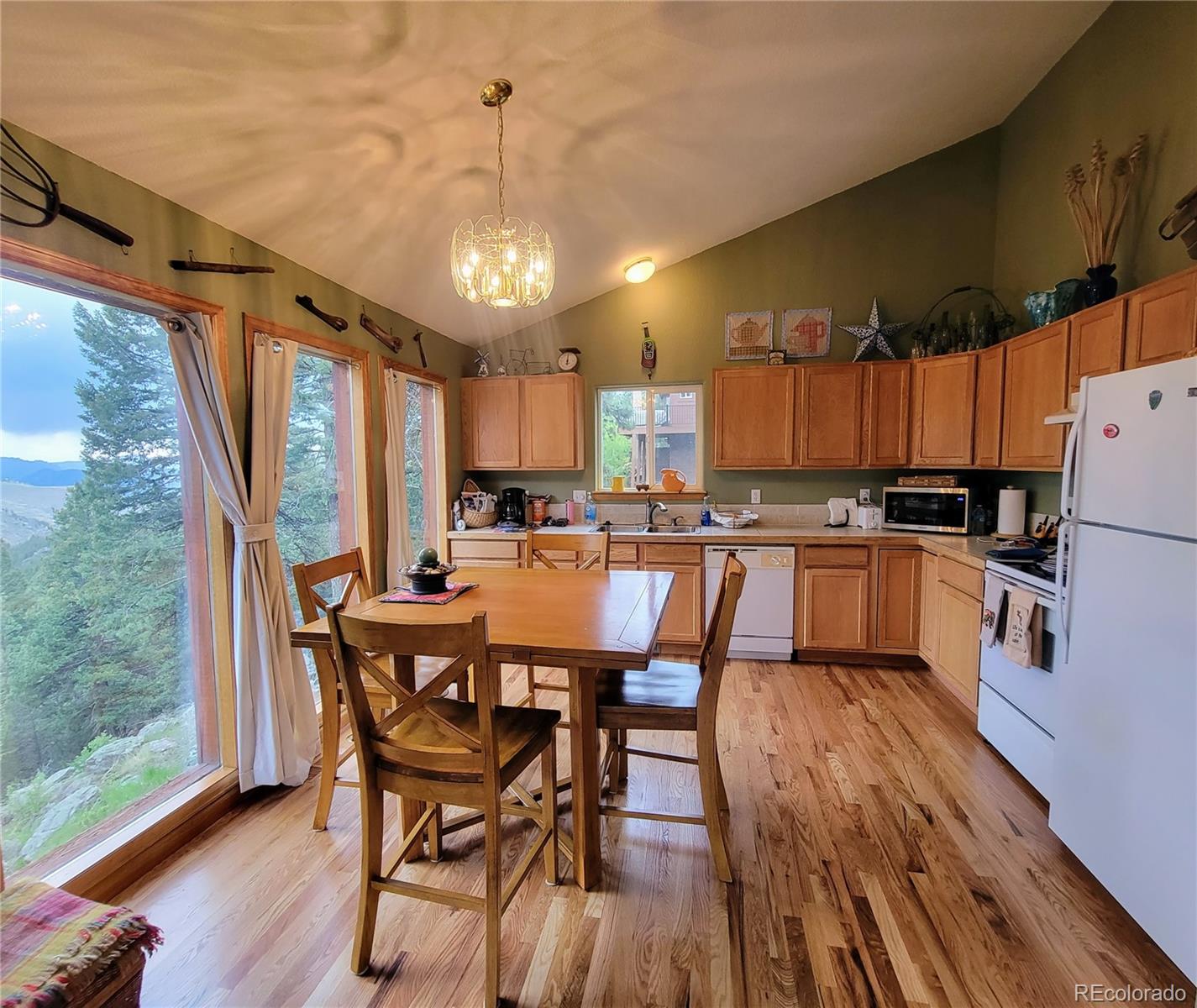 33348 Persistence Avenue Pine, CO 80470 - Photo 12 of 40 a view of a dining room with furniture window and wooden floor