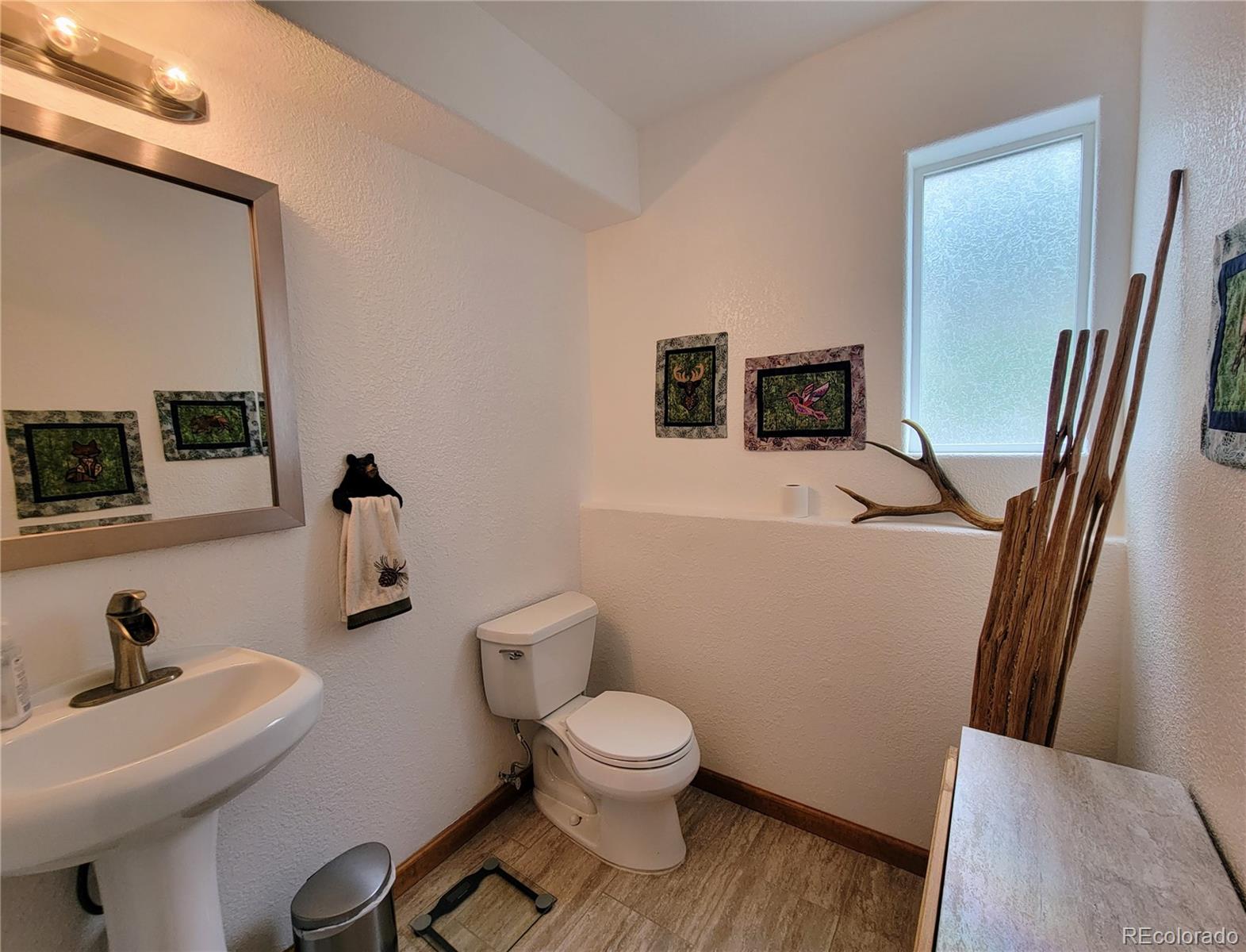 33348 Persistence Avenue Pine, CO 80470 - Photo 19 of 40 a bathroom with a toilet a sink and mirror