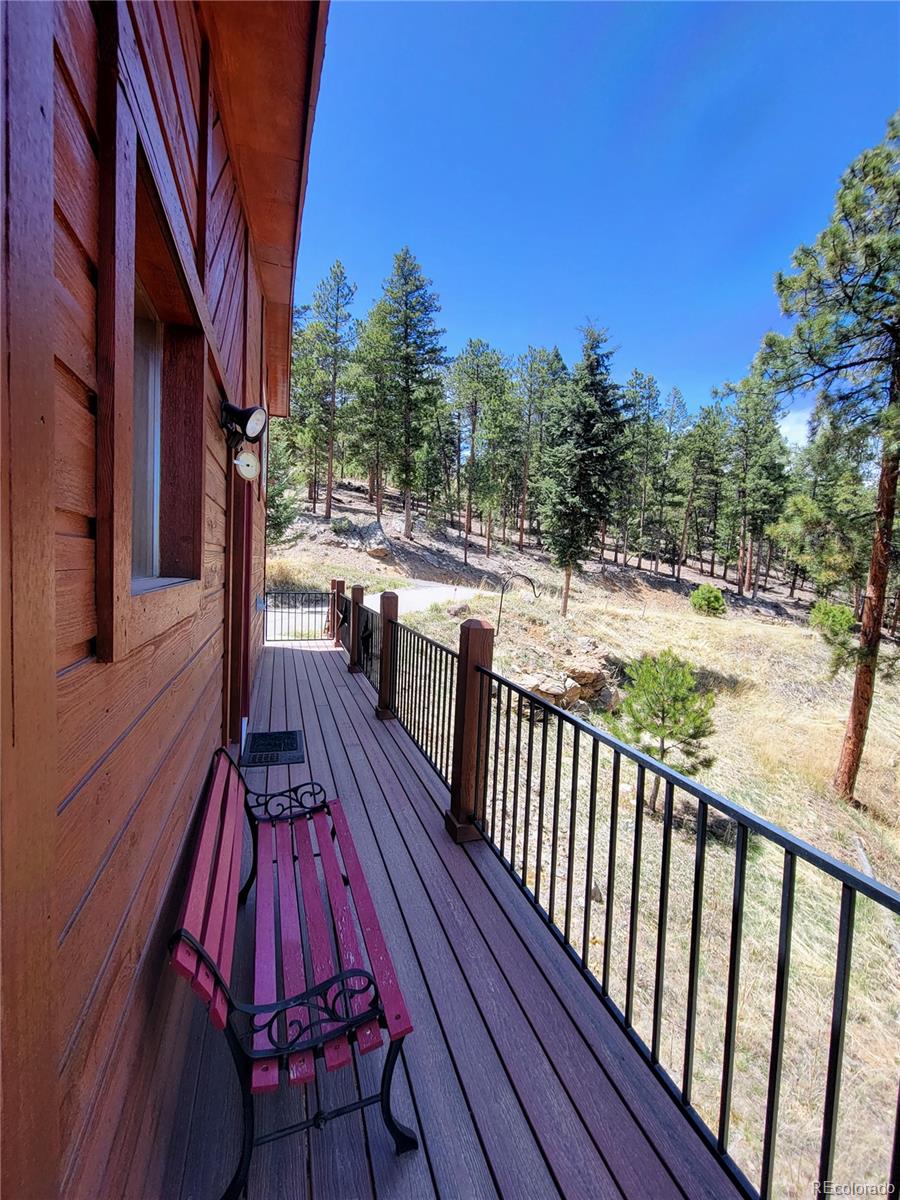 33348 Persistence Avenue Pine, CO 80470 - Photo 29 of 40 a view of balcony with wooden floor and outdoor seating