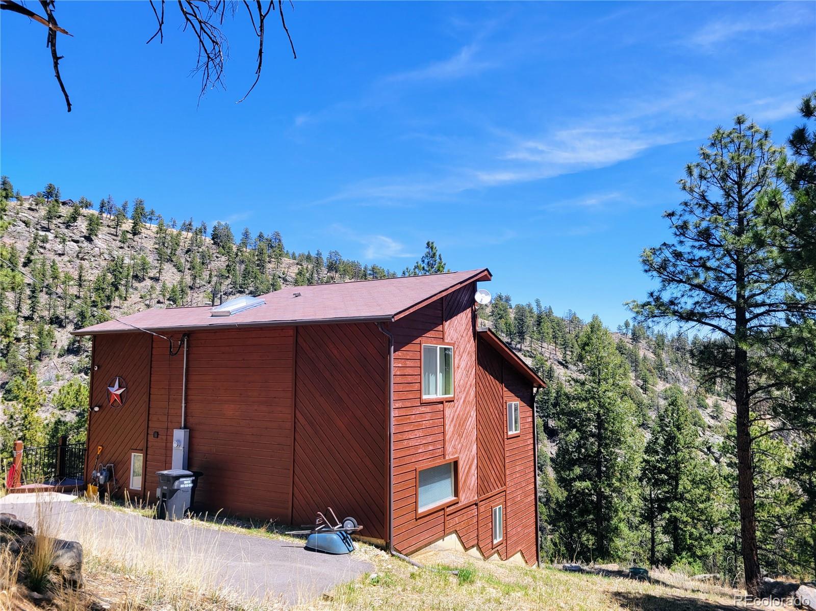 33348 Persistence Avenue Pine, CO 80470 - Photo 30 of 40 a view of a house with a yard