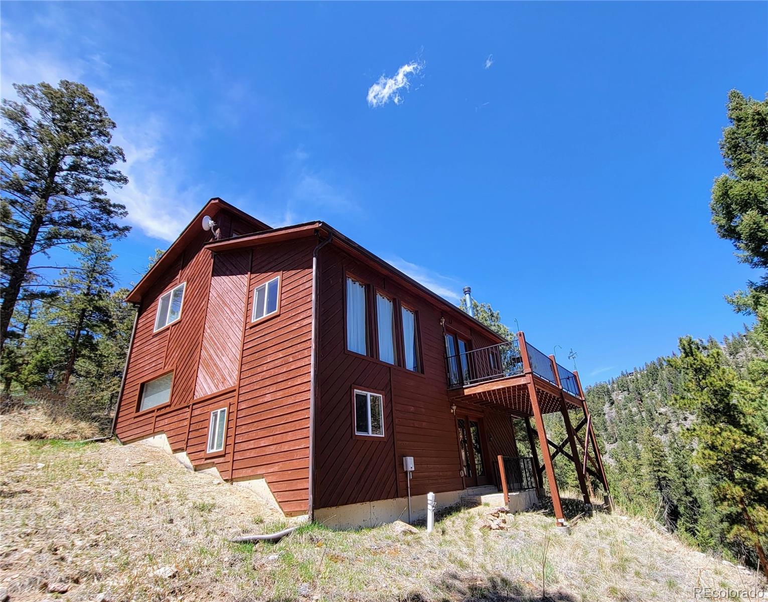 33348 Persistence Avenue Pine, CO 80470 - Photo 3 of 40 a front view of a house with a yard