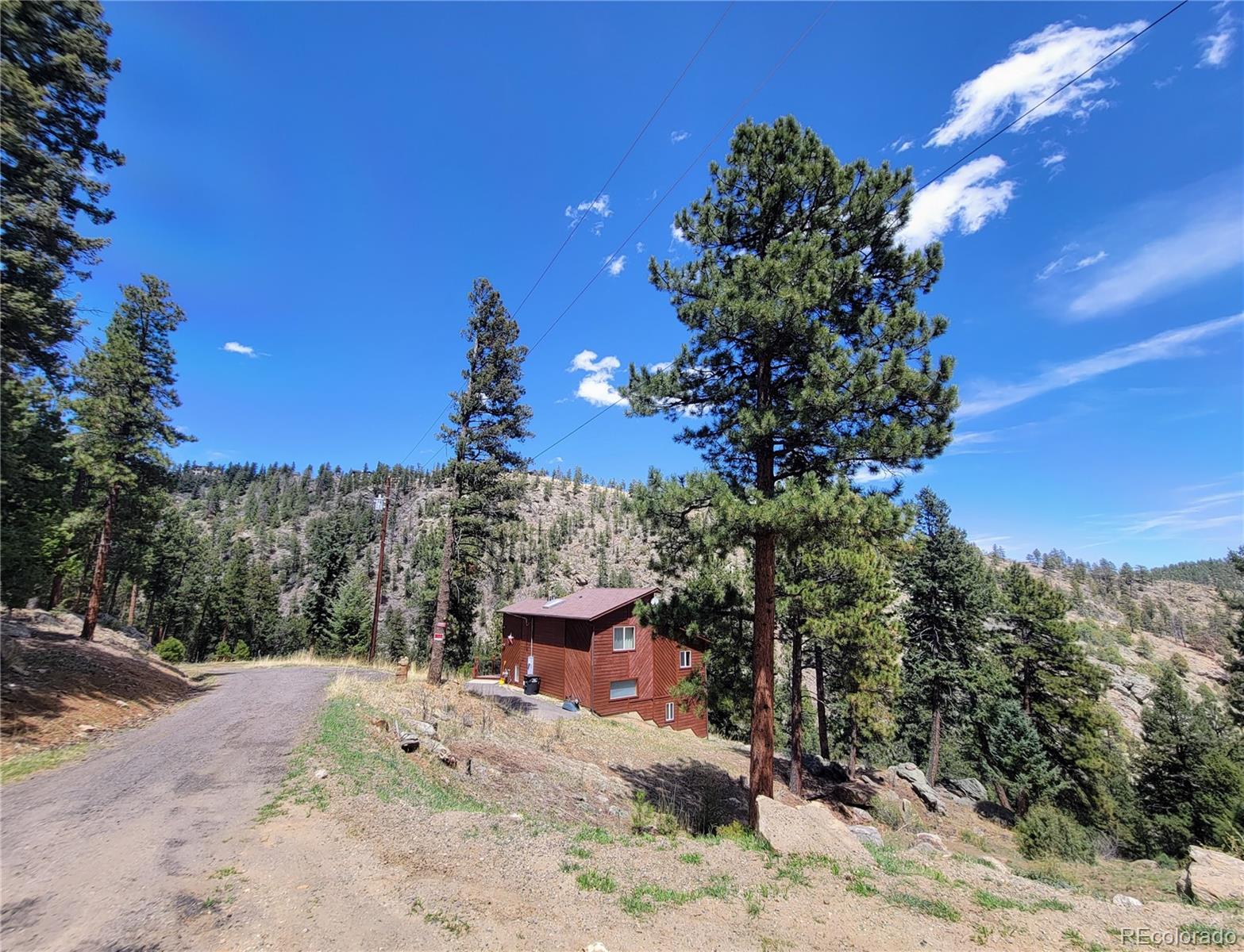 33348 Persistence Avenue Pine, CO 80470 - Photo 31 of 40 a view of a backyard of a house with a mountain