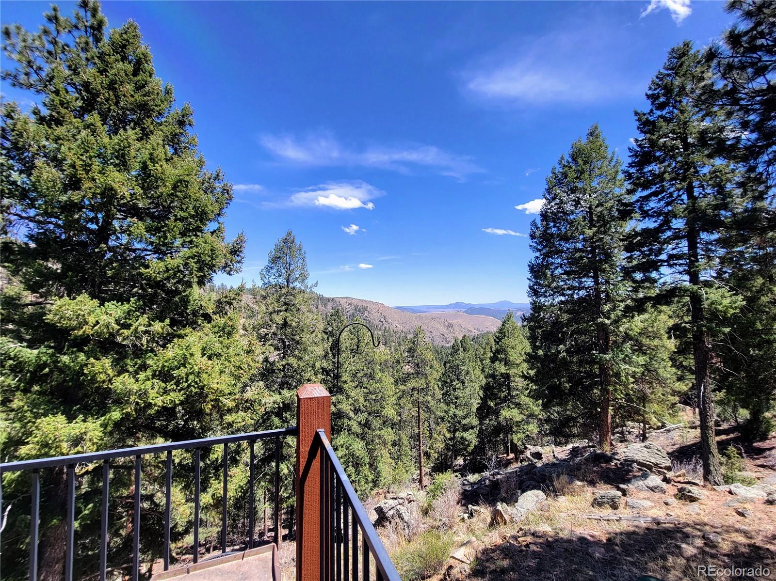 33348 Persistence Avenue Pine, CO 80470 - Photo 40 of 40 a view of a balcony with a tree