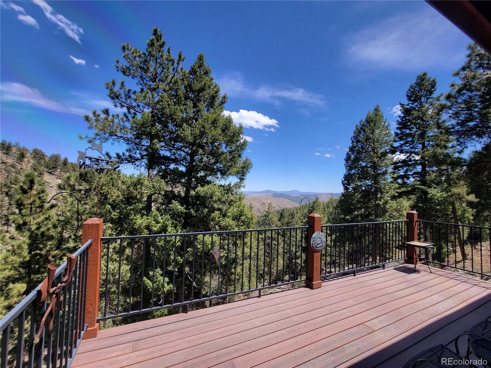 33348 Persistence Avenue Pine, CO 80470 - Photo 4 of 40 a view of a balcony with wooden floor and city view