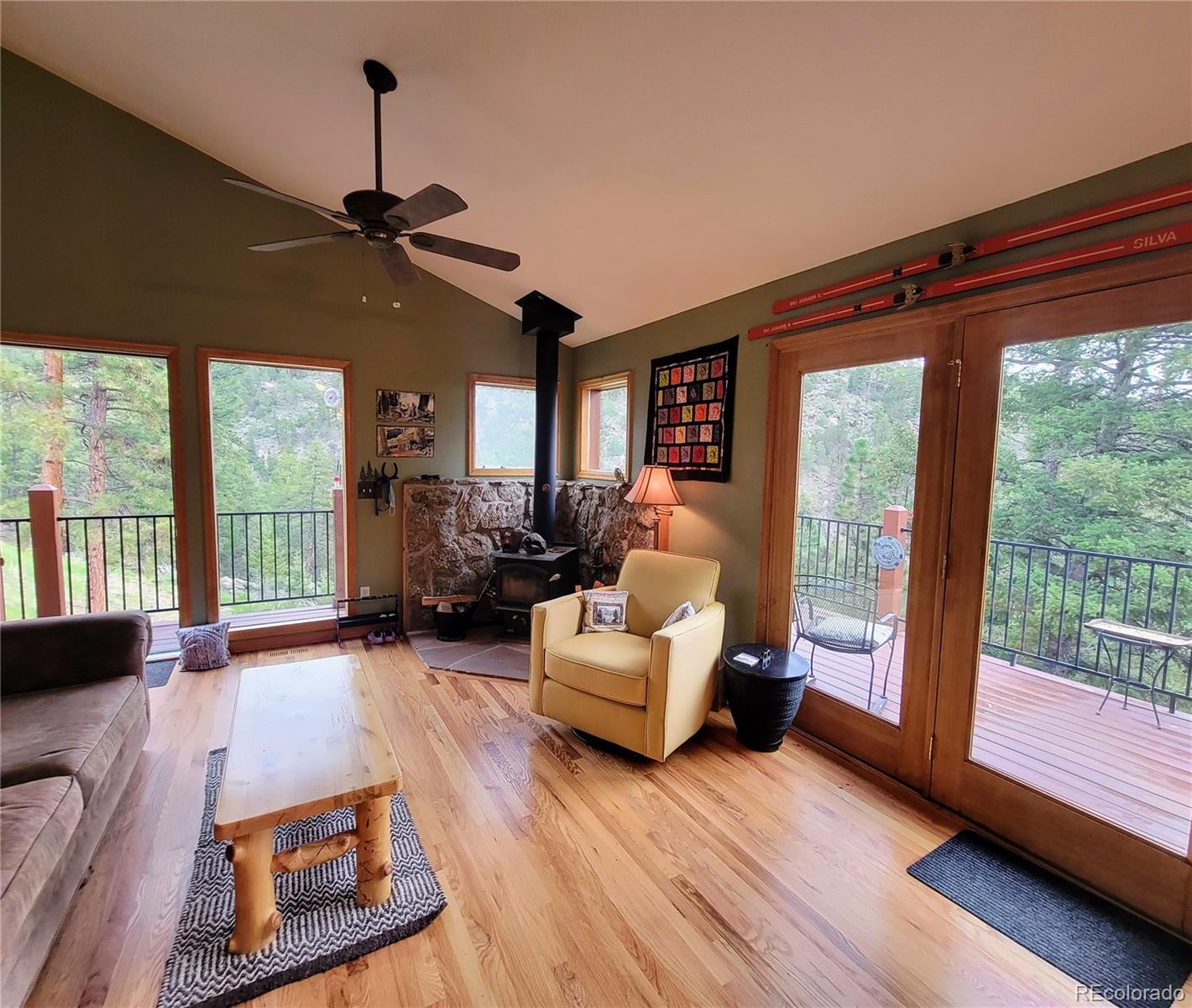 33348 Persistence Avenue Pine, CO 80470 - Photo 5 of 40 a living room with furniture and a floor to ceiling window