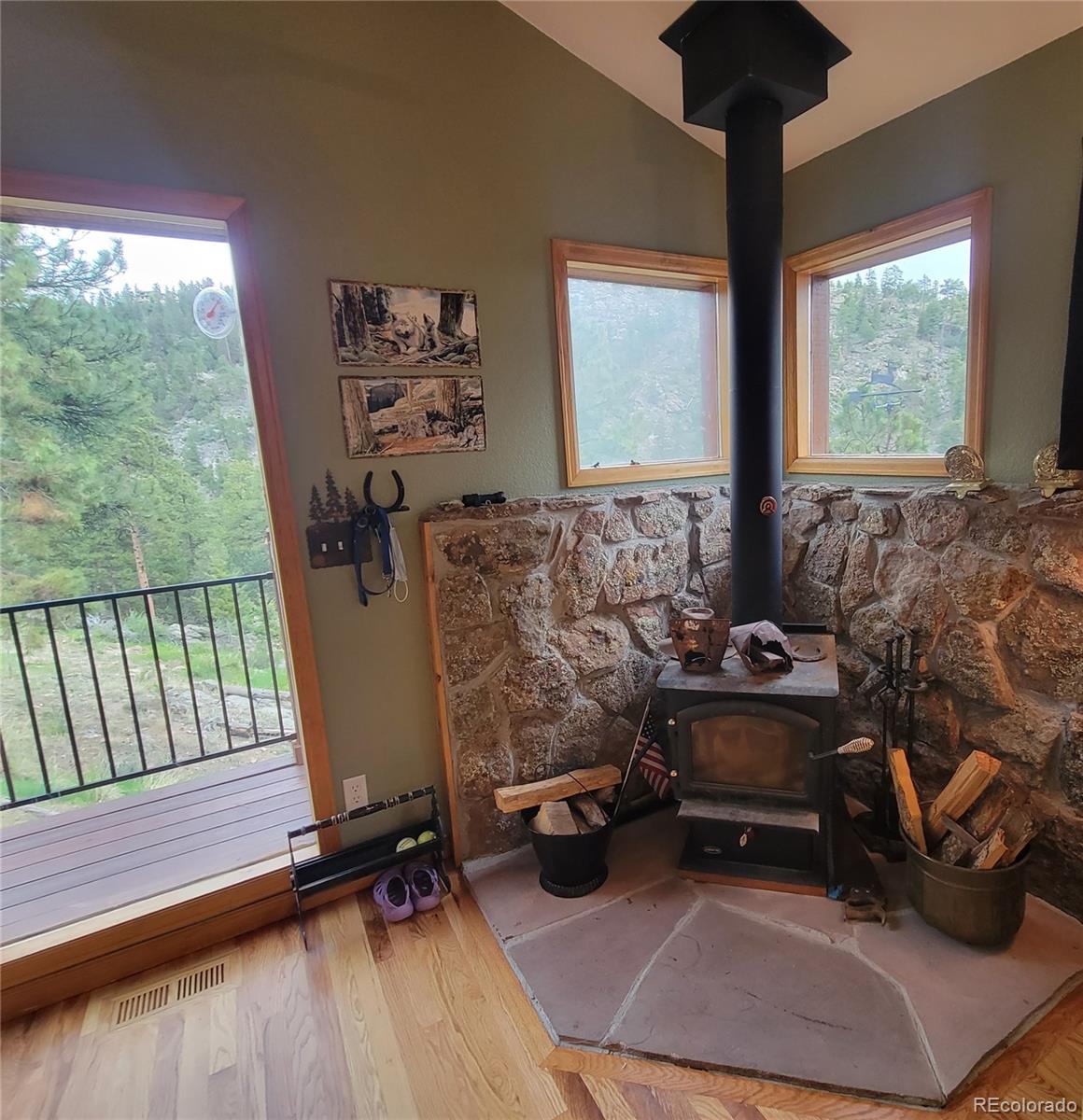 33348 Persistence Avenue Pine, CO 80470 - Photo 9 of 40 a living room with furniture and a floor to ceiling window