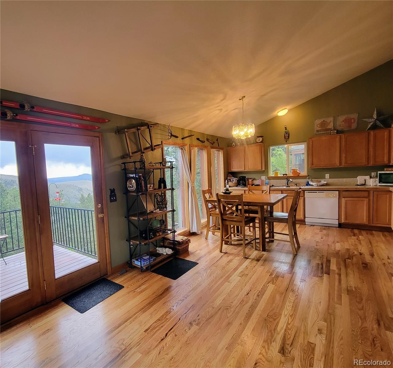 33348 Persistence Avenue Pine, CO 80470 - Photo 10 of 40 a view of a living room a dining room and kitchen with wooden floor