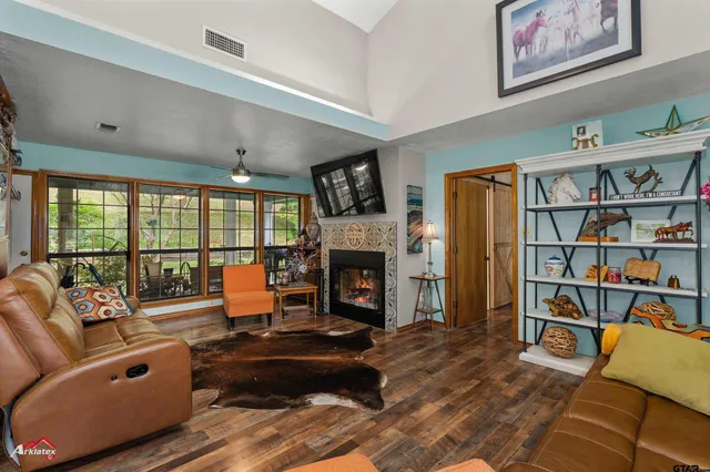 a living room with furniture large window and a fireplace