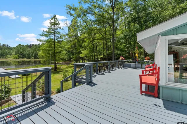 a view of deck with chairs and wooden floor
