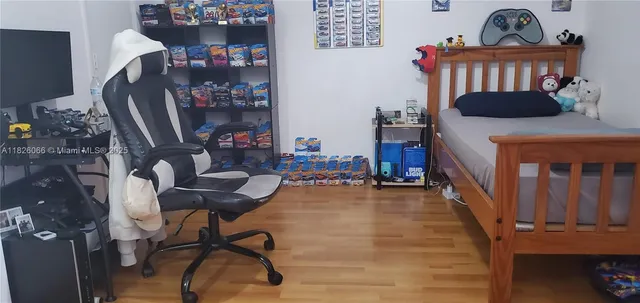 a bedroom with furniture and a book shelf