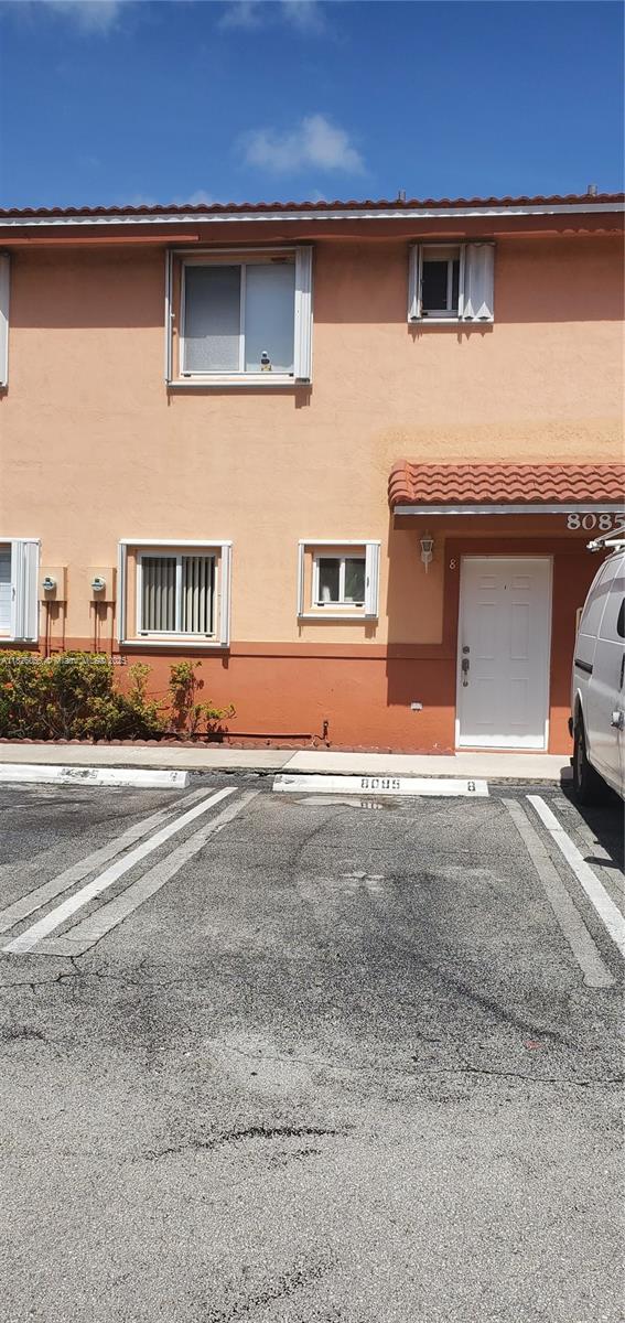 8085 Northwest 8th Street, Unit 6 Miami, FL 33126 - Photo 4 of 15 a front view of a house with a yard