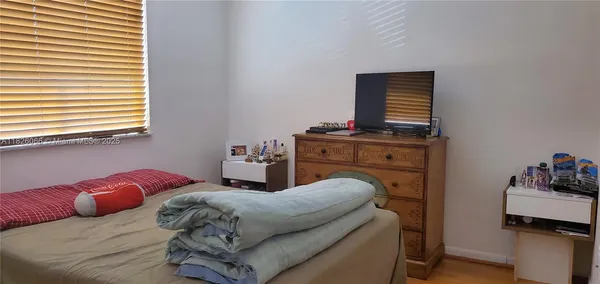 a living room with furniture and dresser