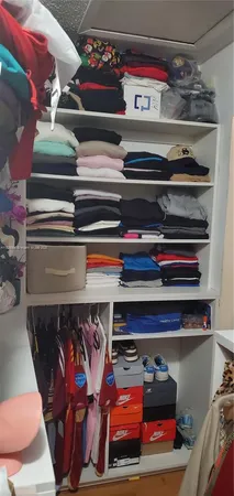 a utility room with lots of different colored cloths