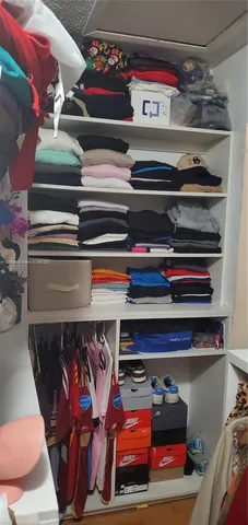 a utility room with lots of different colored cloths