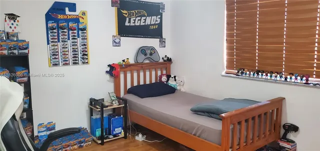 a bedroom with furniture and a window