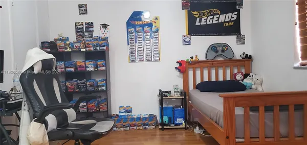 a bedroom with furniture and a book shelf