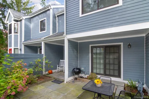a backyard of a house with outdoor seating