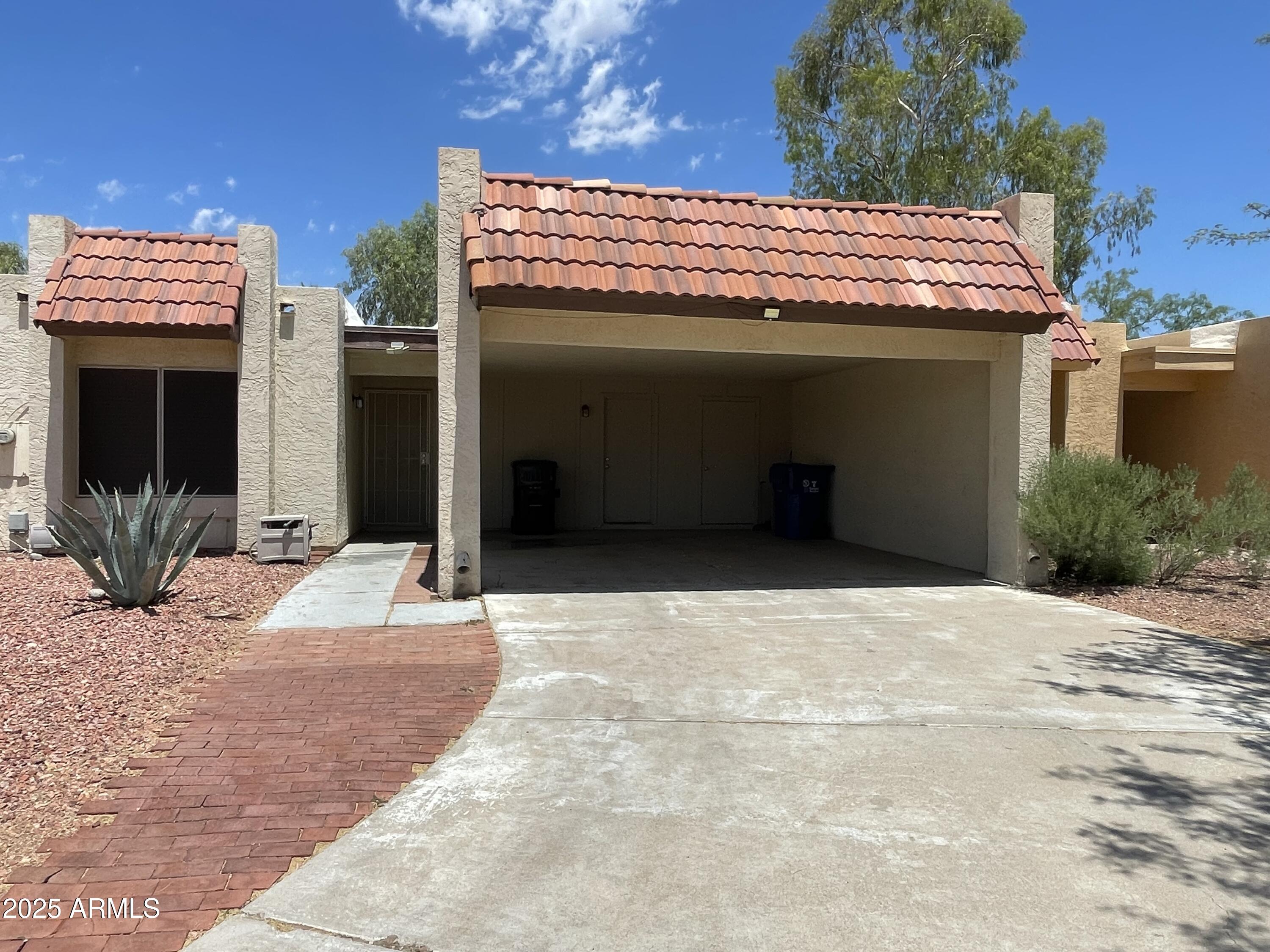 a view of front door and potted plants