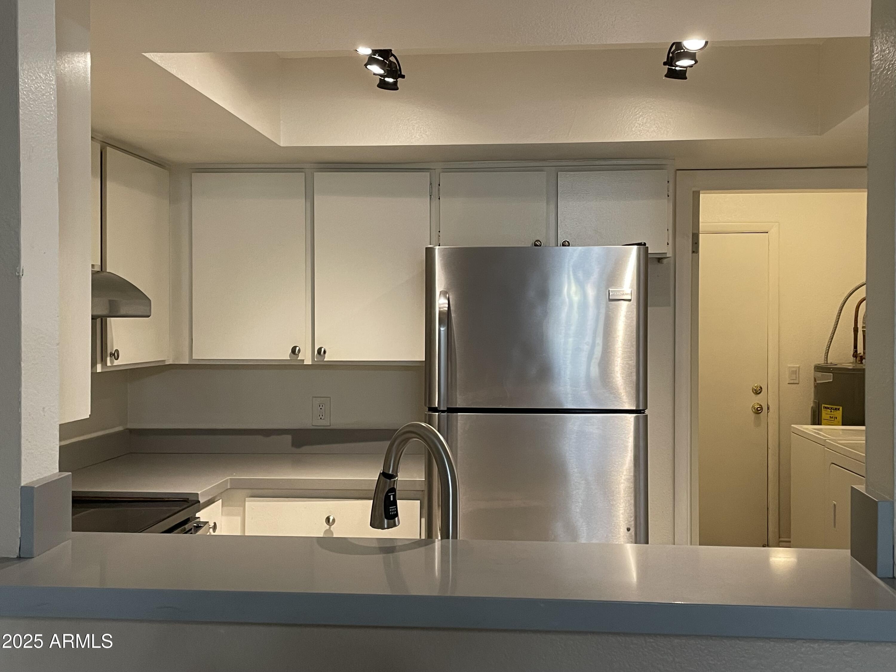 732 West Rice Drive Tempe, AZ 85283 - Photo 4 of 18 a kitchen with a refrigerator a sink and cabinets