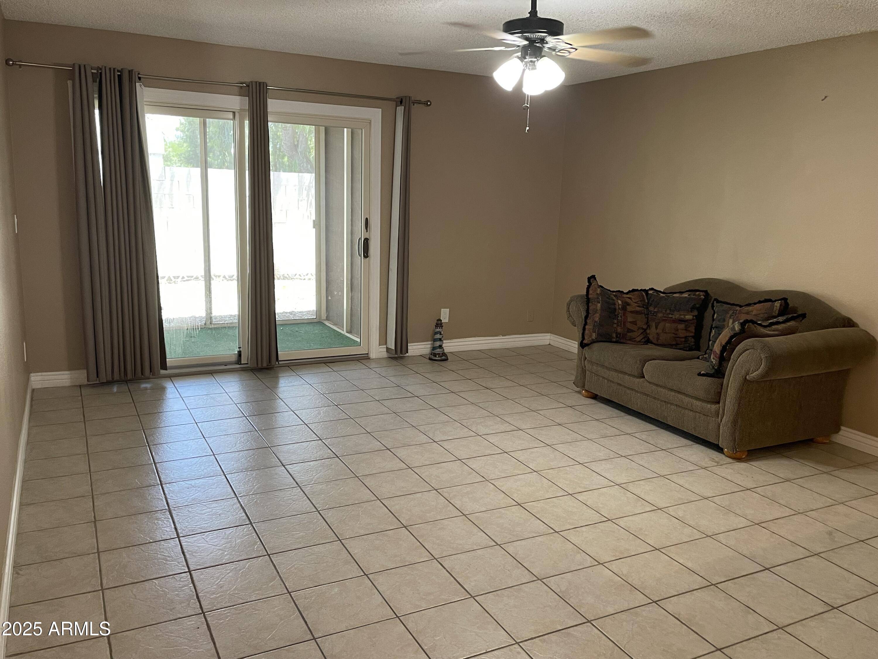 732 West Rice Drive Tempe, AZ 85283 - Photo 5 of 18 a living room with a couch and a large window