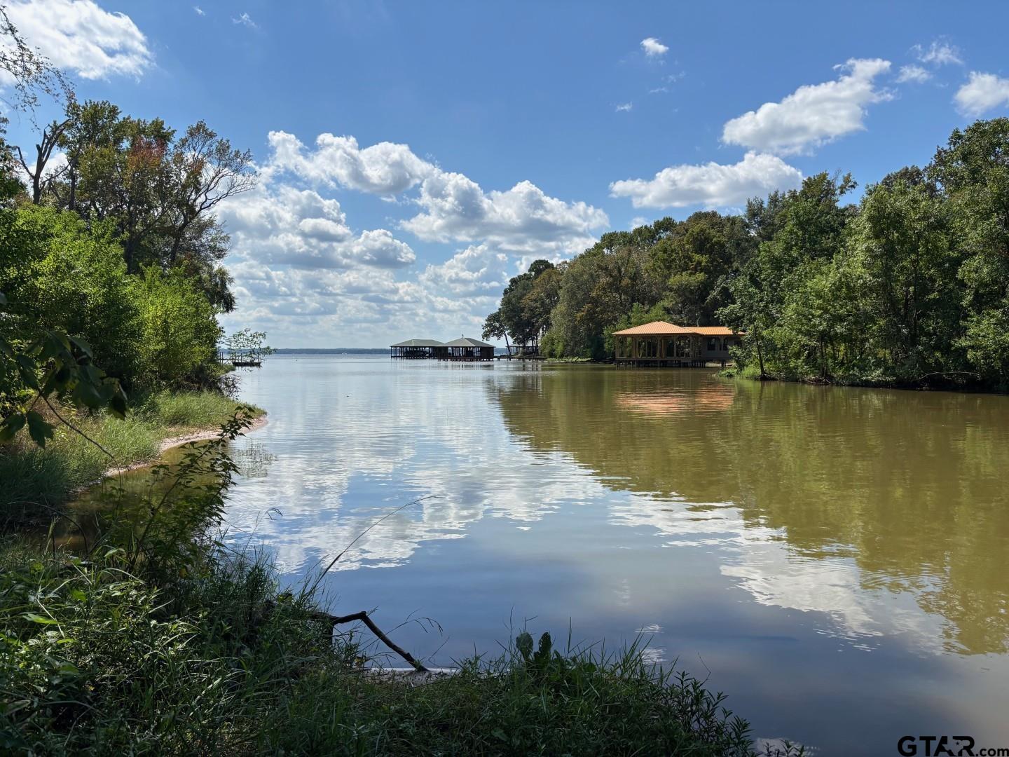an aerial view of a house with a yard and lake view