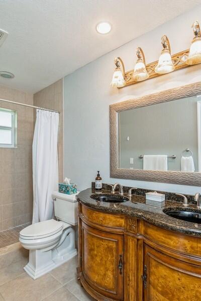 1230 South Drive Way, Unit A Delray Beach, FL 33445 - Photo 17 of 26 a bathroom with a sink a toilet and a mirror