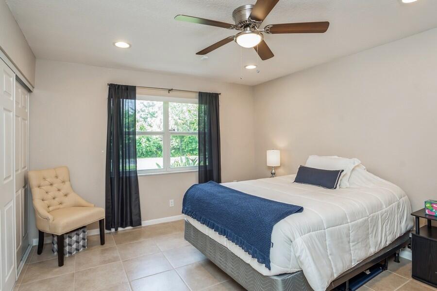 1230 South Drive Way, Unit A Delray Beach, FL 33445 - Photo 19 of 26 a bedroom with a large bed and a window